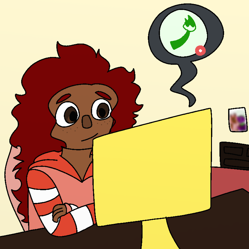Amada smiles at her computer's monitor. A dark gray chat bubble with a light green paintbrush symbol in it floats by the monitor.
